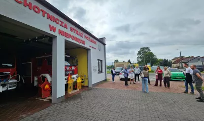 Wprowadzenie wykonawcy na teren budowy - remiza OSP w Nieporęcie. Na zdjęciu wykonawcy i inwestorzy przed budynkiem remizy strażackiej.